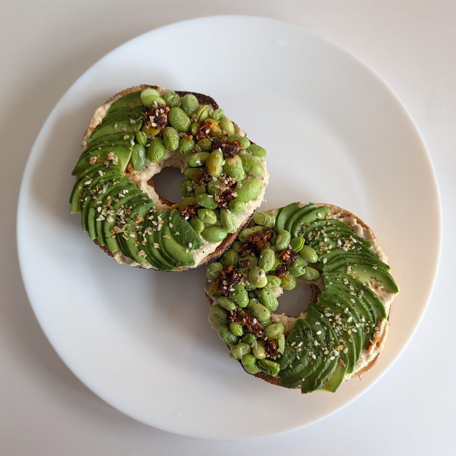 Avocado and edamame bagels with hummus and chilli crisp