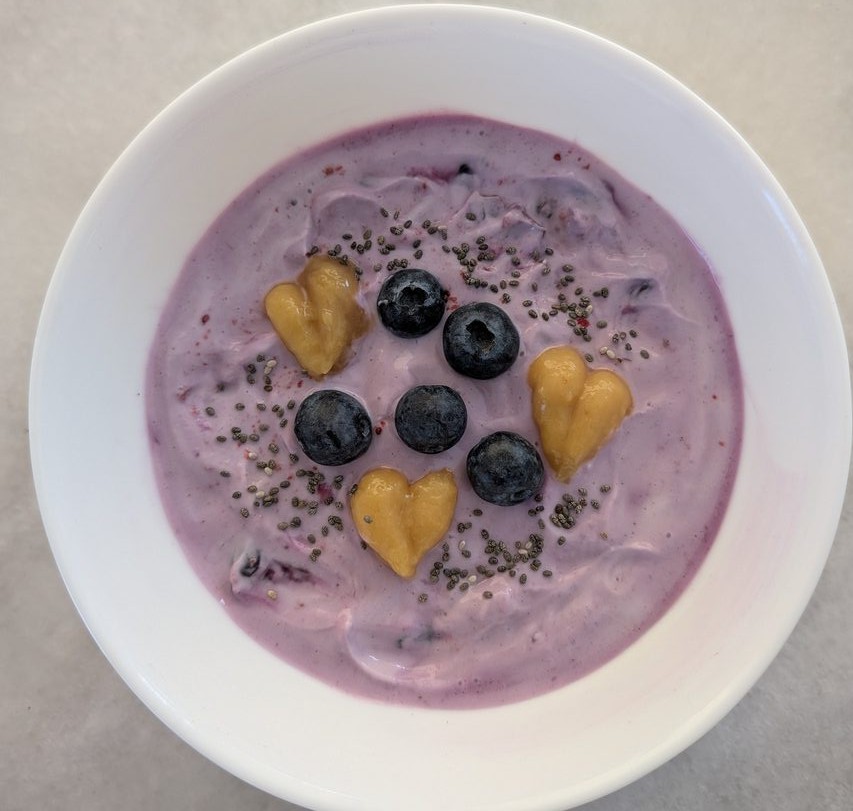 Berry yoghurt bowl with blueberries, mango and chia seeds